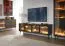 Meuble TV Chaabane 04 / Couleur : Chêne Dunin / Noir / Quatre portes vitrées / Éclairage LED inclus / ABS / Dimensions : 61,6 x 181 x 39 cm / Poignées et Pieds : Métal